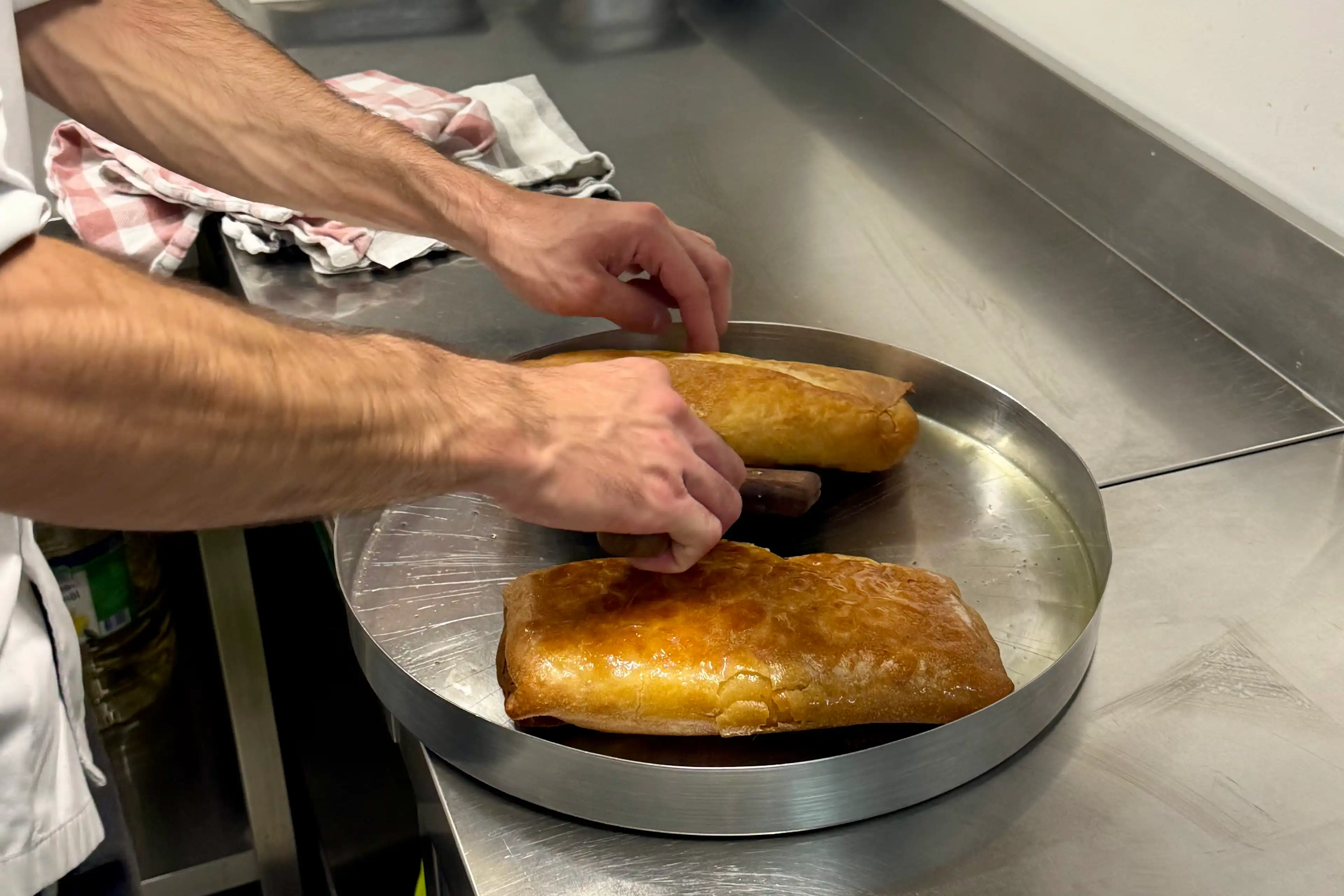 Giorgos turning his handmade bougatsa, which has just come out of the oven.