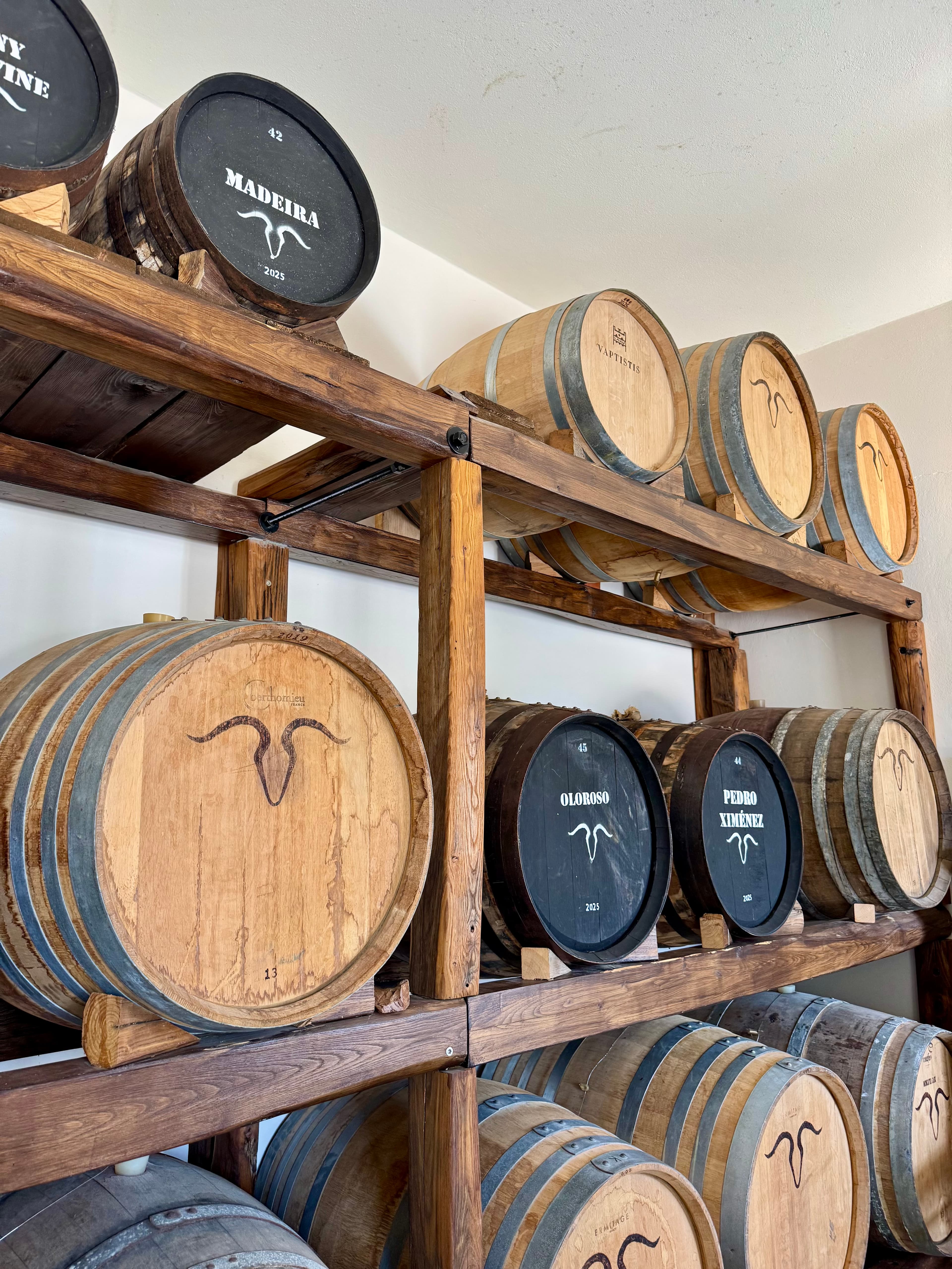 The collection of barrels at the Makryonitis distillery used for aging the spirits.