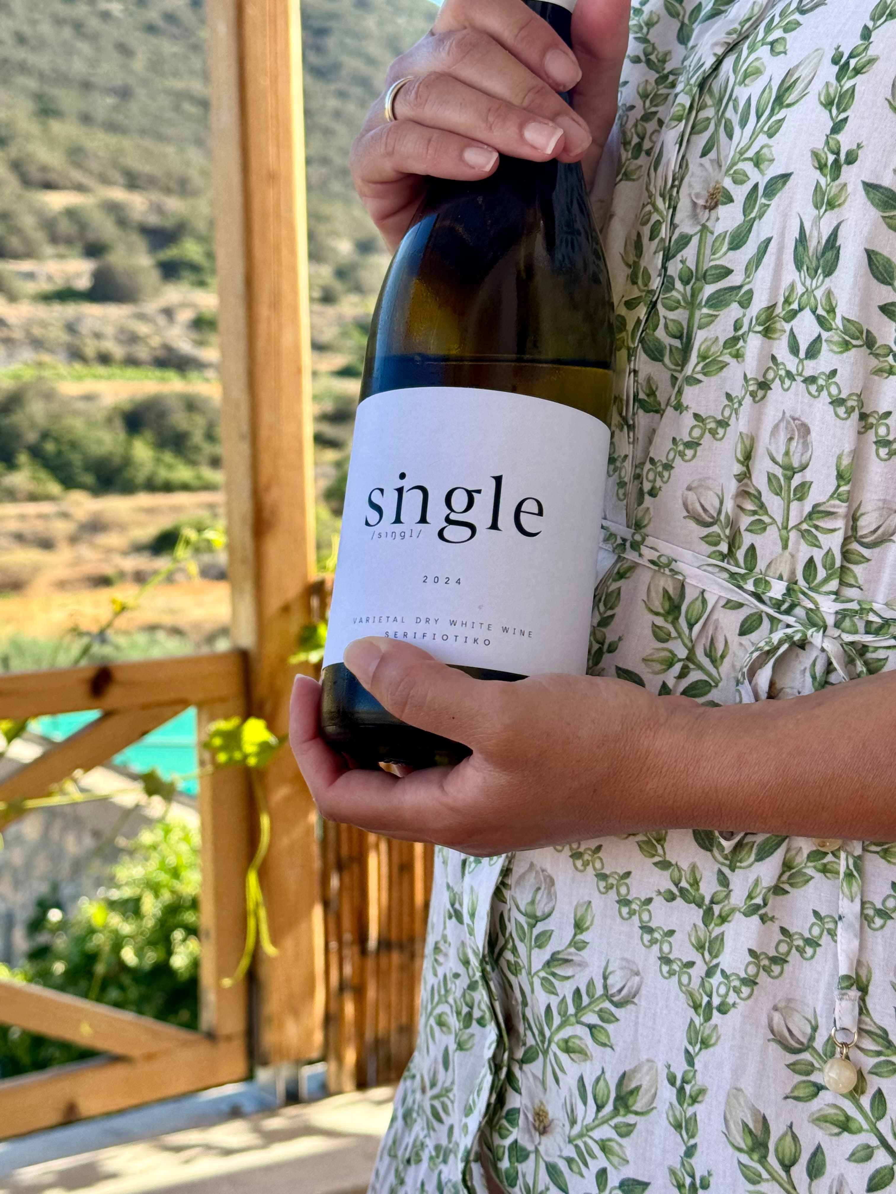 The bottle of Single, with the vineyard in the background.