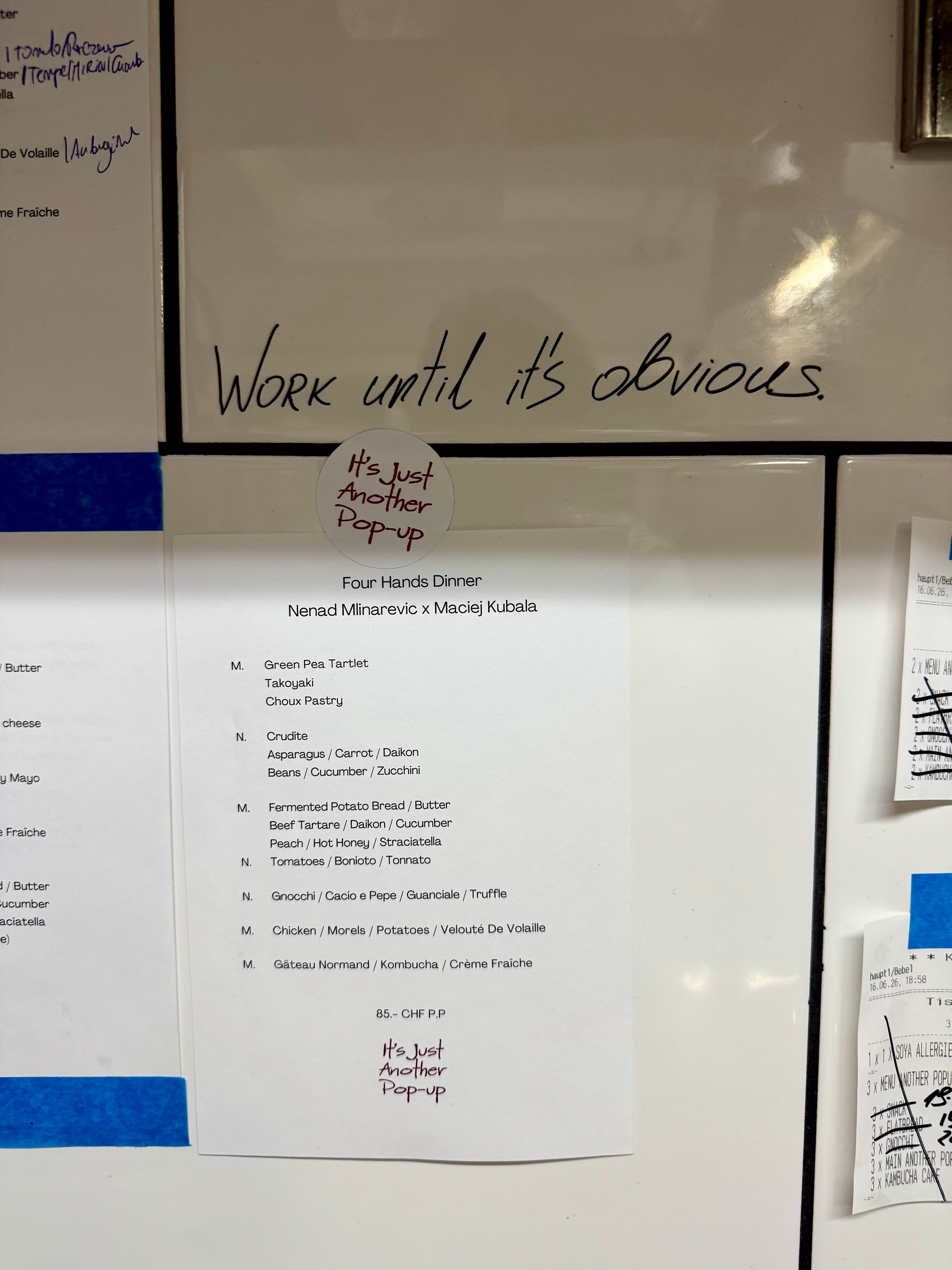 The restaurant's menu above the kitchen counter.