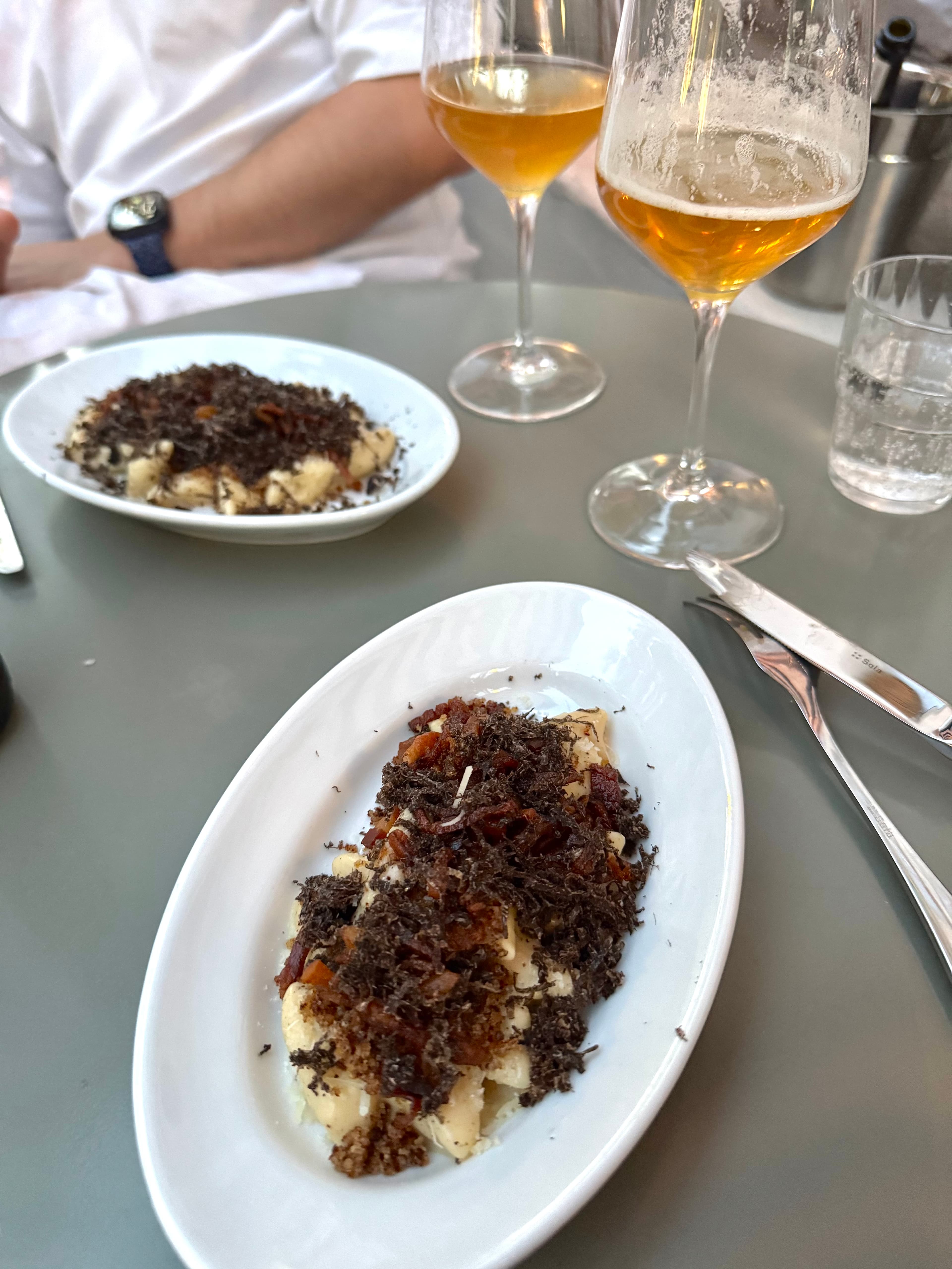Gnocchi with **guanciale** and **cacio e pepe**, served with Hop(e) wine.
