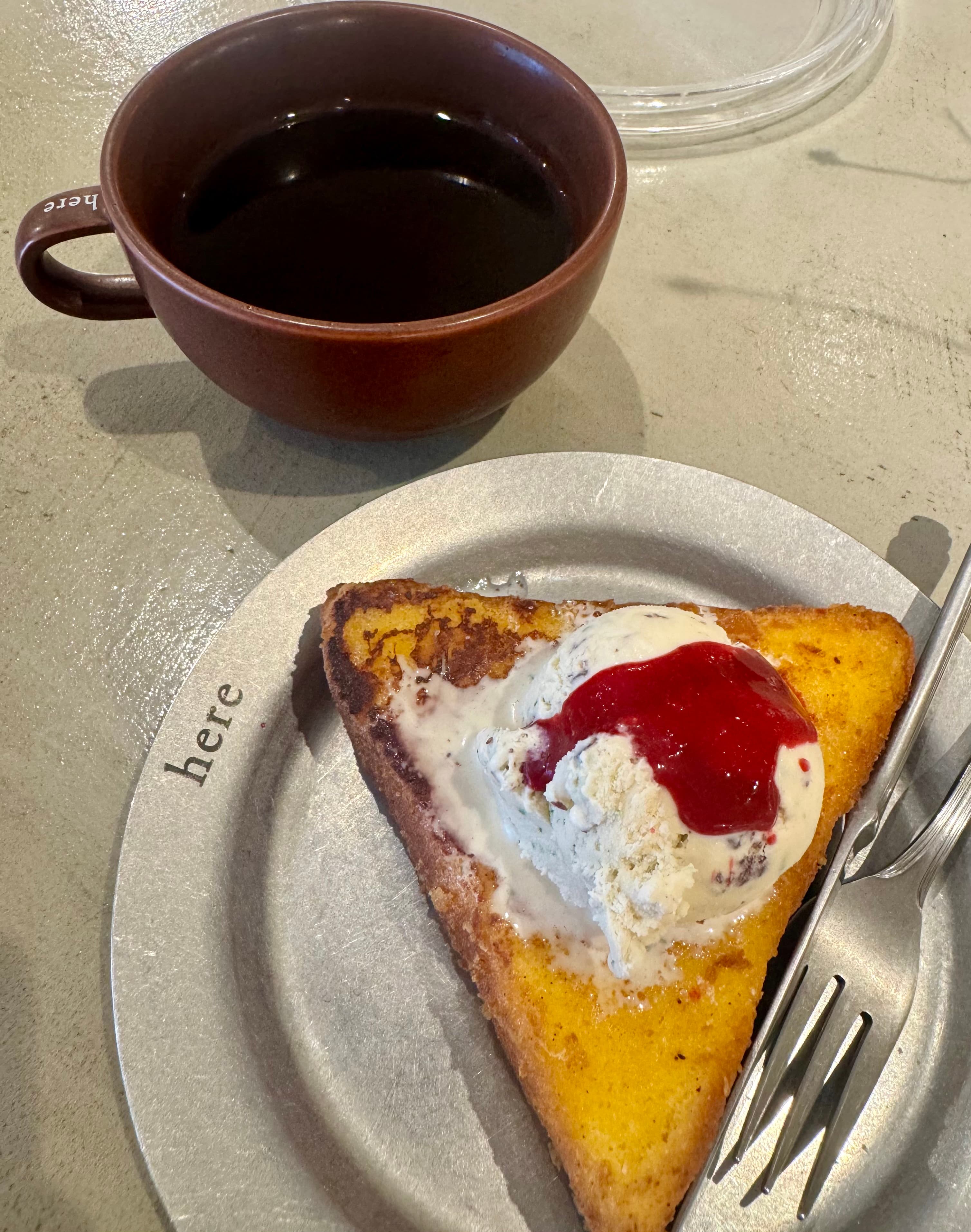 An Americano paired with the delicious french toast with ice cream at here.