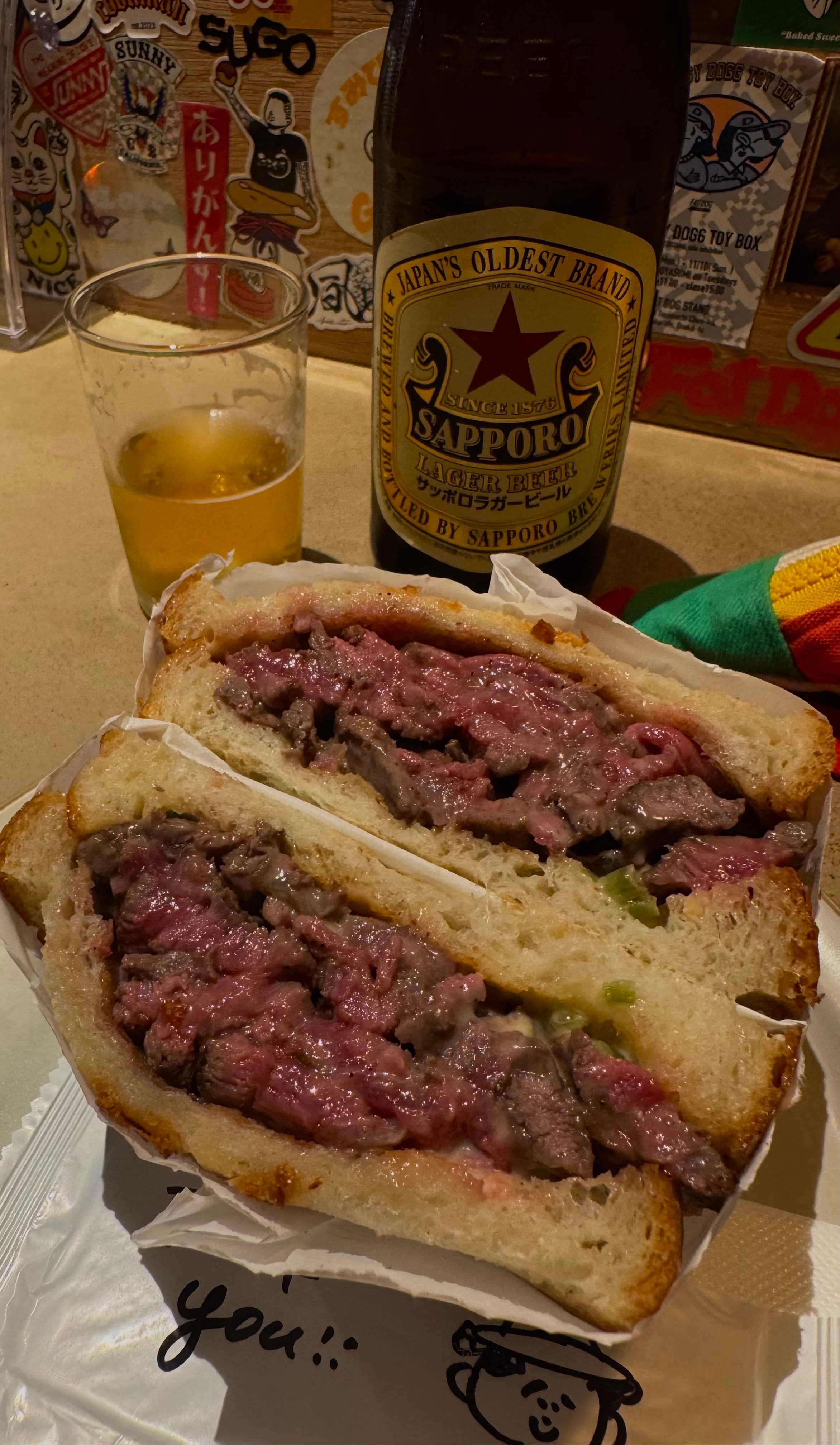The incredible **wagyu (和牛)** sandwich at **Tokito (と木と)**, paired with a cold Sapporo.