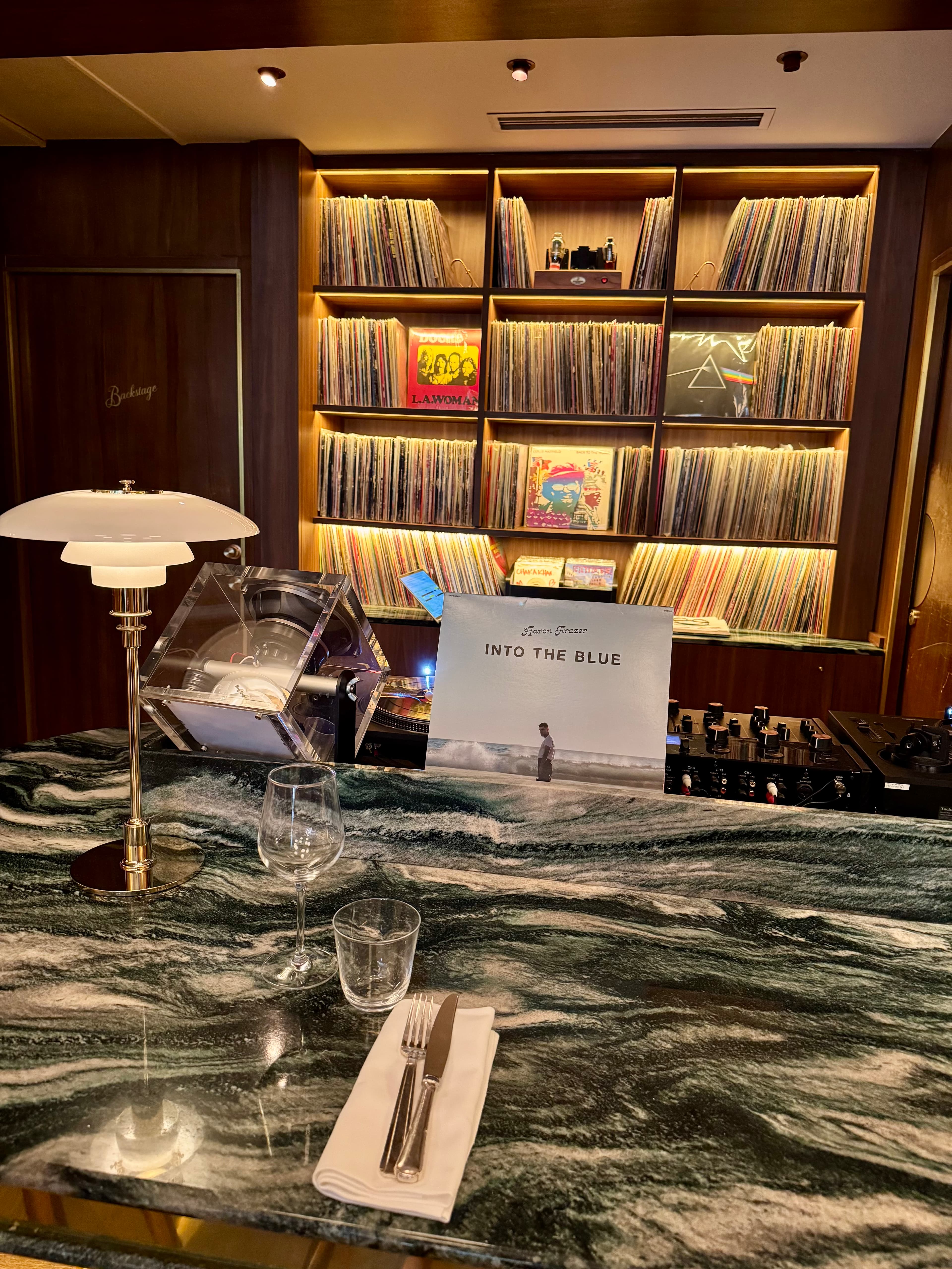 The green marble bar, perfect for a cocktail or a meal, with the vinyl collection as a backdrop.